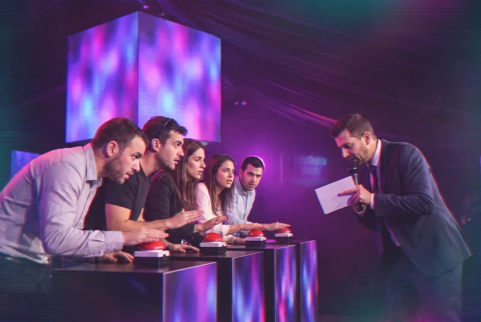 The host facing the five contestants
